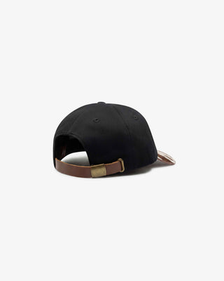 Back of 6 panel black cap with brown leather strap and cowhide brim on white background